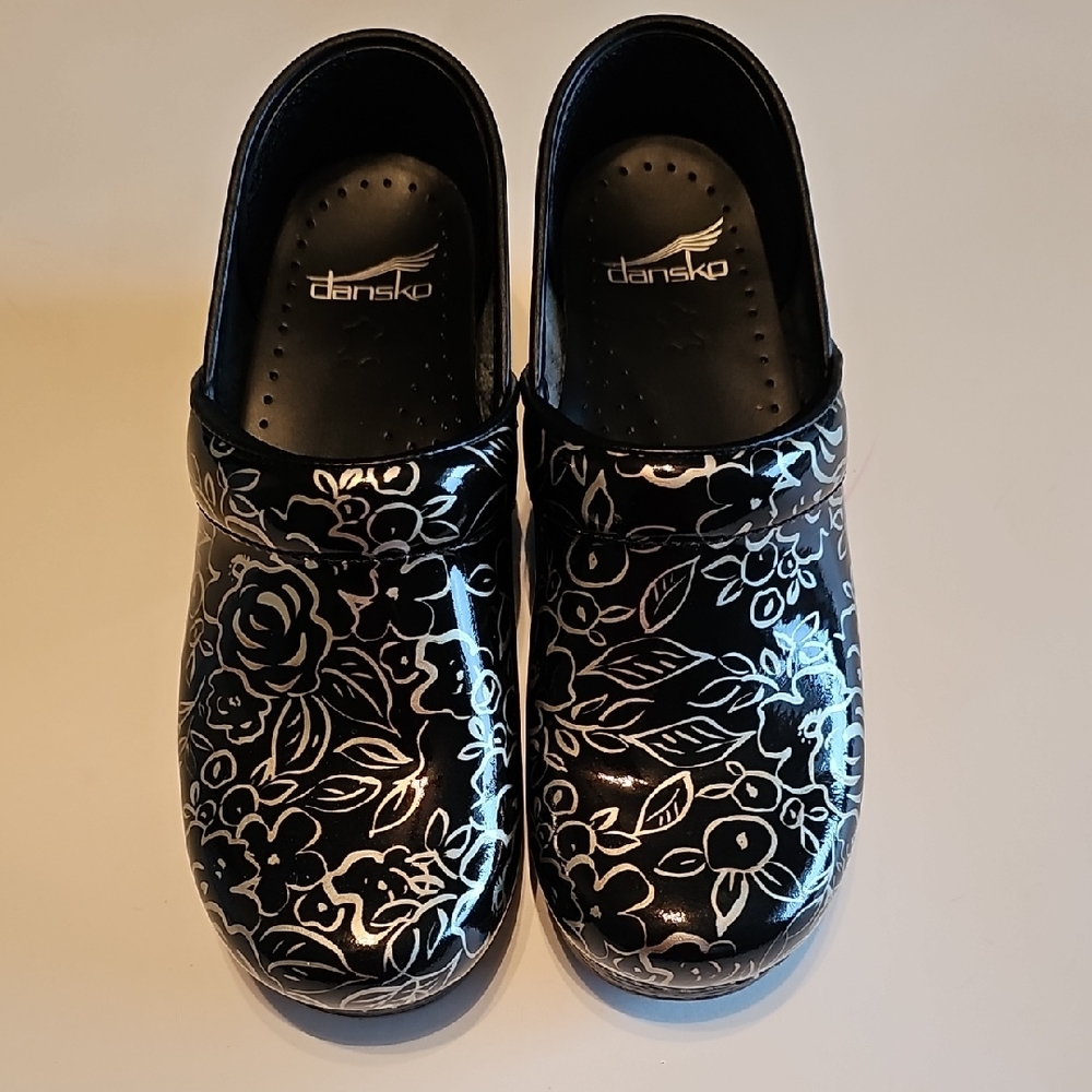 Dansko Black Patent Clogs with White Floral Pattern